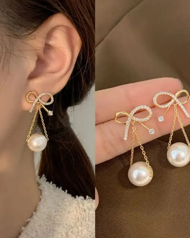 Golden bow hanging earnings