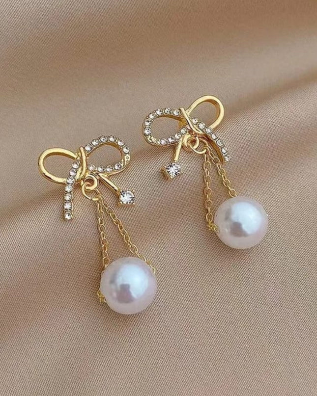 Golden bow hanging earnings