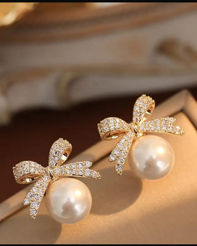 Bow pearl stud earnings